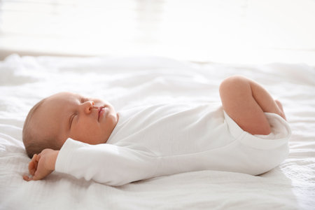 Cute newborn baby sleeping on bed indoorsの写真素材