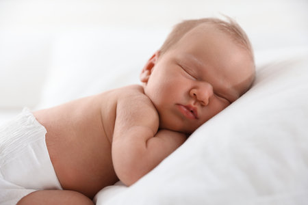 Cute newborn baby sleeping on pillow indoorsの写真素材