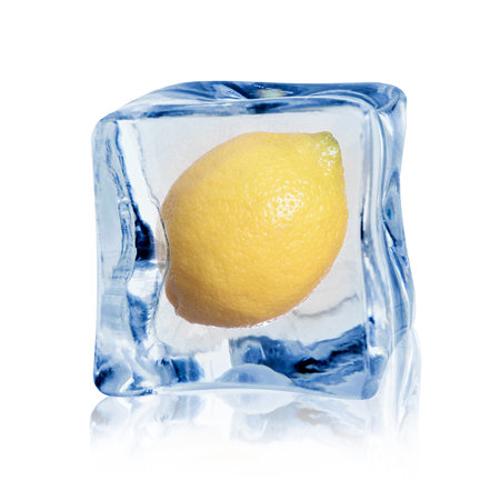 Fresh ripe lemon fruit in ice cube isolated on whiteの写真素材