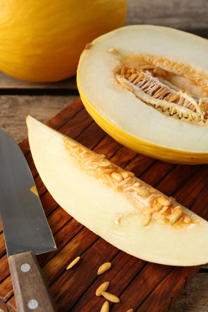 Cut and whole ripe melons on wooden table, closeupの写真素材