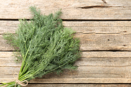 Bunch of fresh dill on wooden table, top view. Space for textの写真素材