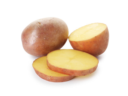 Whole and cut fresh potatoes isolated on whiteの写真素材