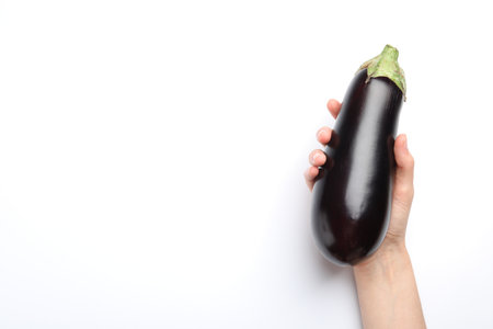 Woman with fresh eggplant on white background, top view. Space for textの写真素材