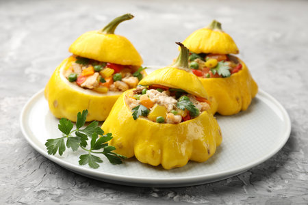 Tasty stuffed pattypan squashes on grey textured table, closeupの写真素材