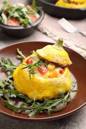 Tasty stuffed pattypan squash with arugula on grey table, closeupの写真素材