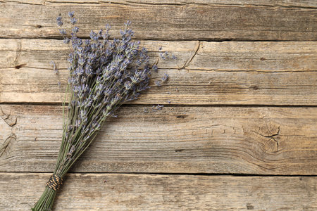 Bunch of aromatic lavender flowers on wooden table, top view. Space for textの写真素材