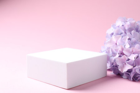 Promotion. Podium for product presentation and hydrangea flowers on pink background, closeupの写真素材