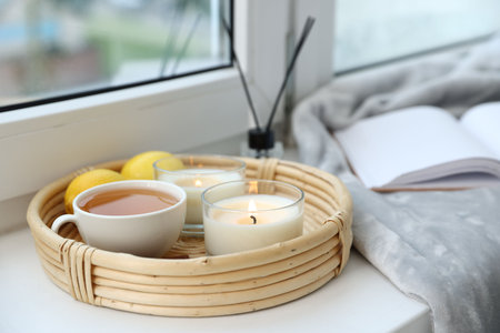 Spa composition with burning candles and reed air freshener on windowsill, closeupの写真素材