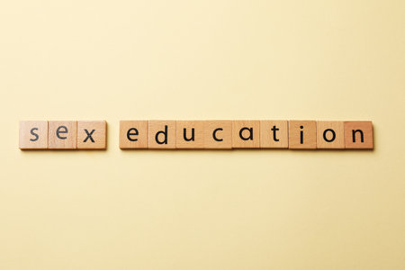 Words Sex Education made of wooden squares with letters on beige background, flat layの写真素材
