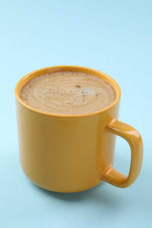 Aromatic coffee in cup on light blue background, closeupの写真素材
