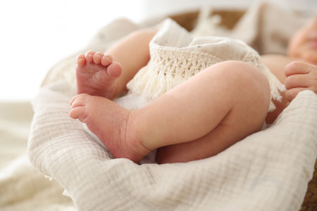 Cute newborn child lying in baby nest indoors, closeupの写真素材