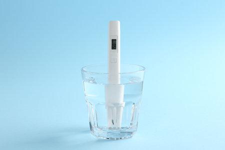 Nitrate tester in glass of water on light blue background, closeupの写真素材