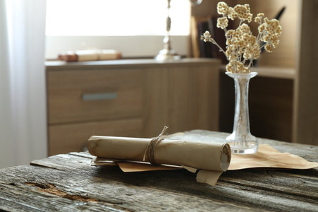 Old paper scrolls and sheets on wooden tableの写真素材