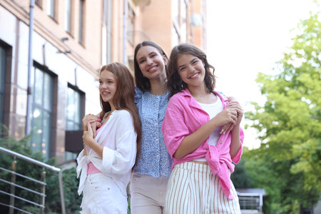 Portrait of happy friends on city street, low angle view