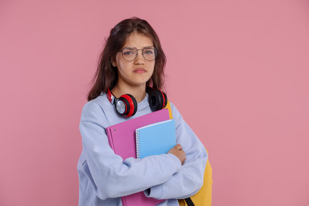 Student worried about her exam result on pink backgroundの写真素材