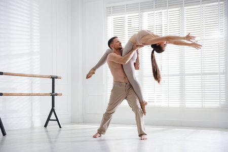 Couple of professional dancers training in studioの写真素材