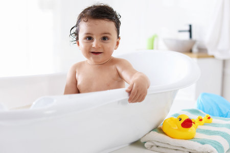 Cute little baby bathing in tub at homeの写真素材