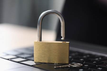 Cyber safety. Metal padlock on laptop, closeupの写真素材