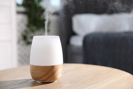 One stylish aroma lamp on wooden table indoors, closeup