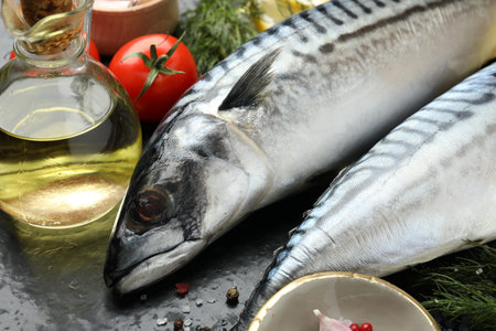 Fresh raw mackerels and spices on table, closeup. Seafood delicaciesの写真素材