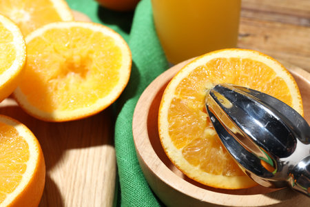 Making fresh juice. Juicer and oranges on table, closeup