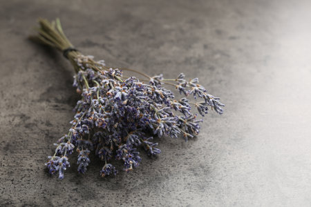 Bunch of aromatic lavender flowers on gray table, closeup. Space for textの写真素材