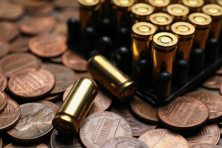 Many firearms cartridges on coins, closeup viewの写真素材