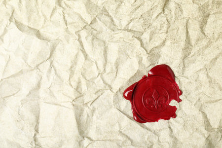 Red wax seal on crumpled paper, top view. Space for textの写真素材