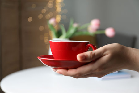 Woman with cup of tea at home, closeupの写真素材