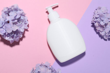 Cosmetic product and flowers on color background, flat lay. Mockup for designの写真素材