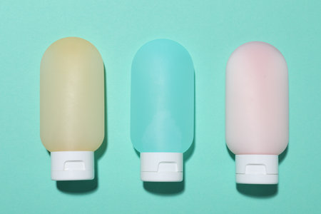 Cosmetic products on turquoise background, flat lay. Mockup for designの写真素材