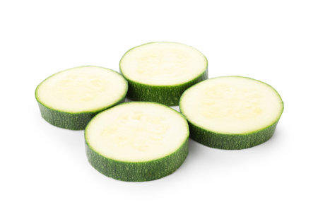 Pieces of fresh zucchini isolated on whiteの写真素材