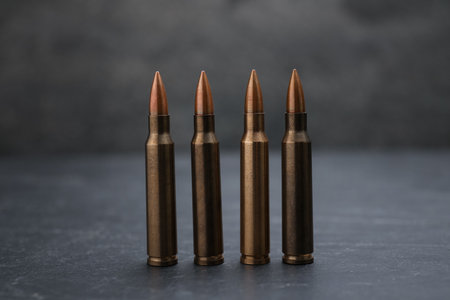 Firearm cartridges on gray table against smoke, closeupの写真素材