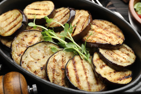 Grilled slices of eggplant with microgreens served on wooden table, closeupの写真素材