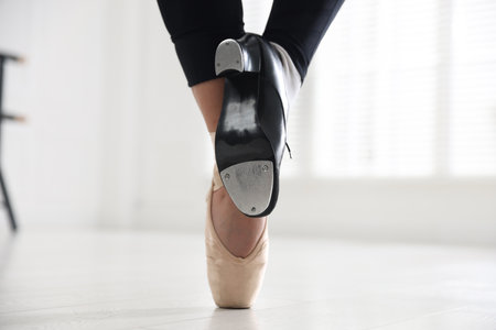 Teenage girl in tap and pointe shoe indoors, closeupの写真素材