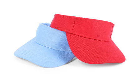 Red and light blue visor caps isolated on white. Mockup for designの写真素材