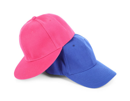 Pink and blue baseball caps isolated on white. Mockup for designの写真素材