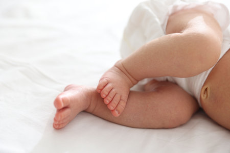 Cute newborn baby lying on bed, closeupの写真素材