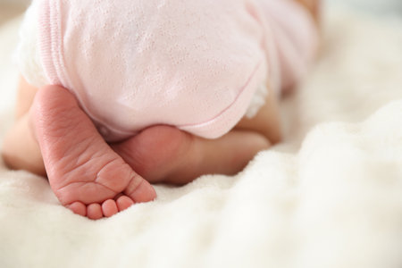 Cute newborn baby lying on bed, closeupの写真素材