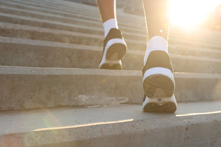 Teenage boy running up stairs outdoors, closeup