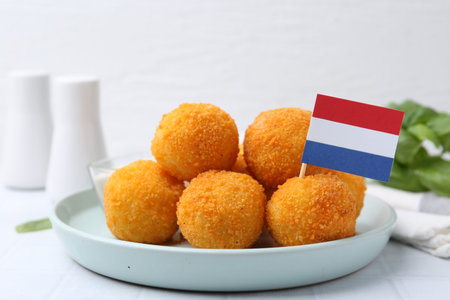 Delicious fried croquette balls on light table, closeup