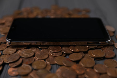 Smartphone and money on grey wooden table, closeupの写真素材