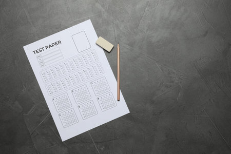 Student passing exam. Answer sheet, pencil and eraser on gray textured table, flat lay. Space for textの写真素材
