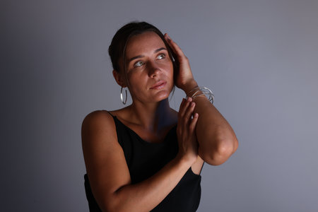 Beautiful woman with bracelet on gray backgroundの写真素材