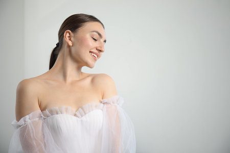 Woman in beautiful wedding dress at home, space for textの写真素材