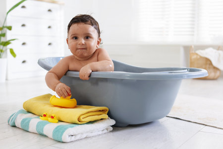 Cute little baby bathing in tub at homeの写真素材