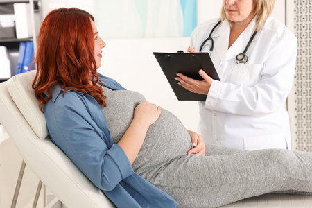 Pregnant woman having appointment with doctor in clinic