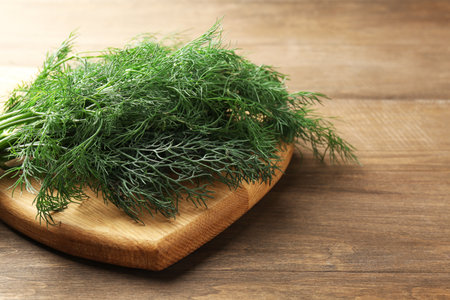 Bunch of fresh dill on wooden table, closeupの写真素材