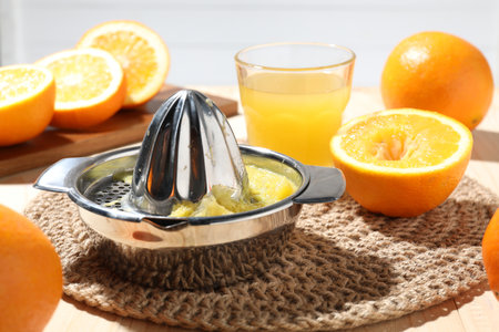 Freshly squeezed orange juice, fruits and juicer on table, closeupの写真素材