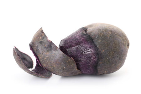 Purple potato with peel isolated on whiteの写真素材